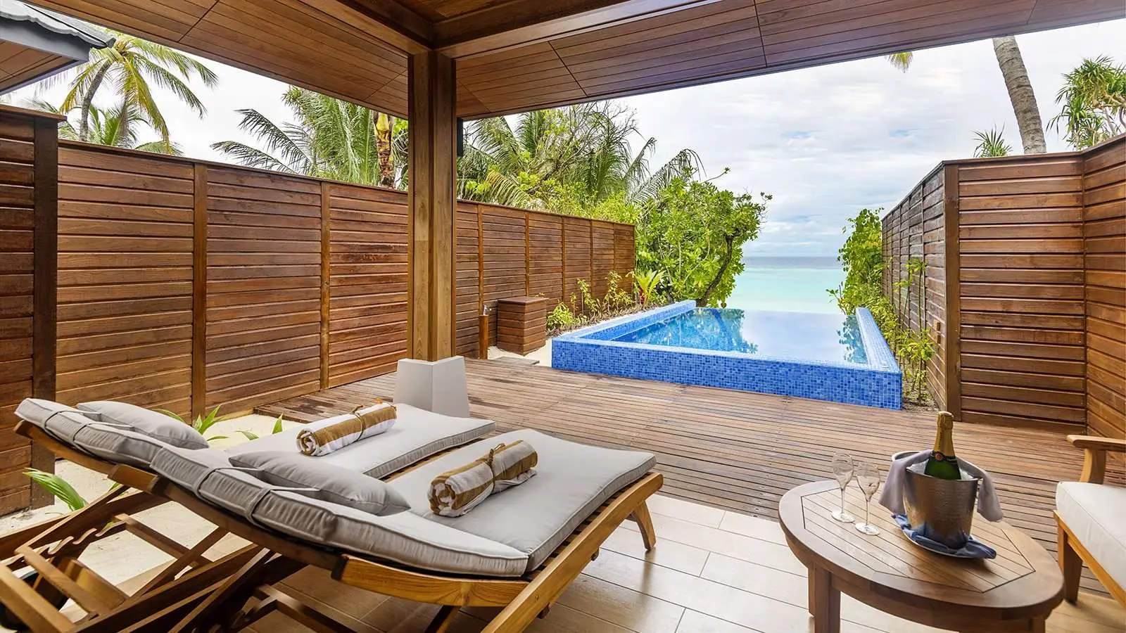 A Beach Suite with Pool’s deck pool, the sea beyond the wall