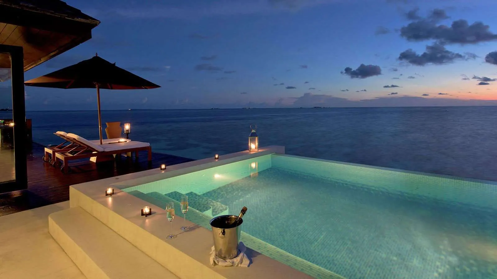 A Sunset Water Suite’s infinity pool at sunset