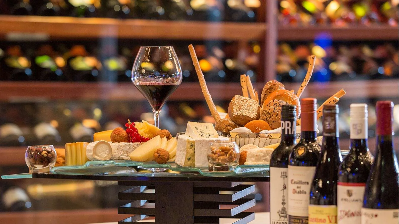 Cheeses, bread and bottles of wine on Lily Maa’s counter