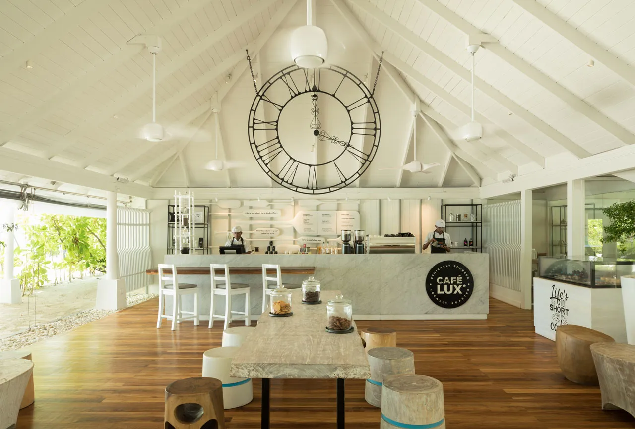 Café LUX* with its big clock, the counter and wooden tables