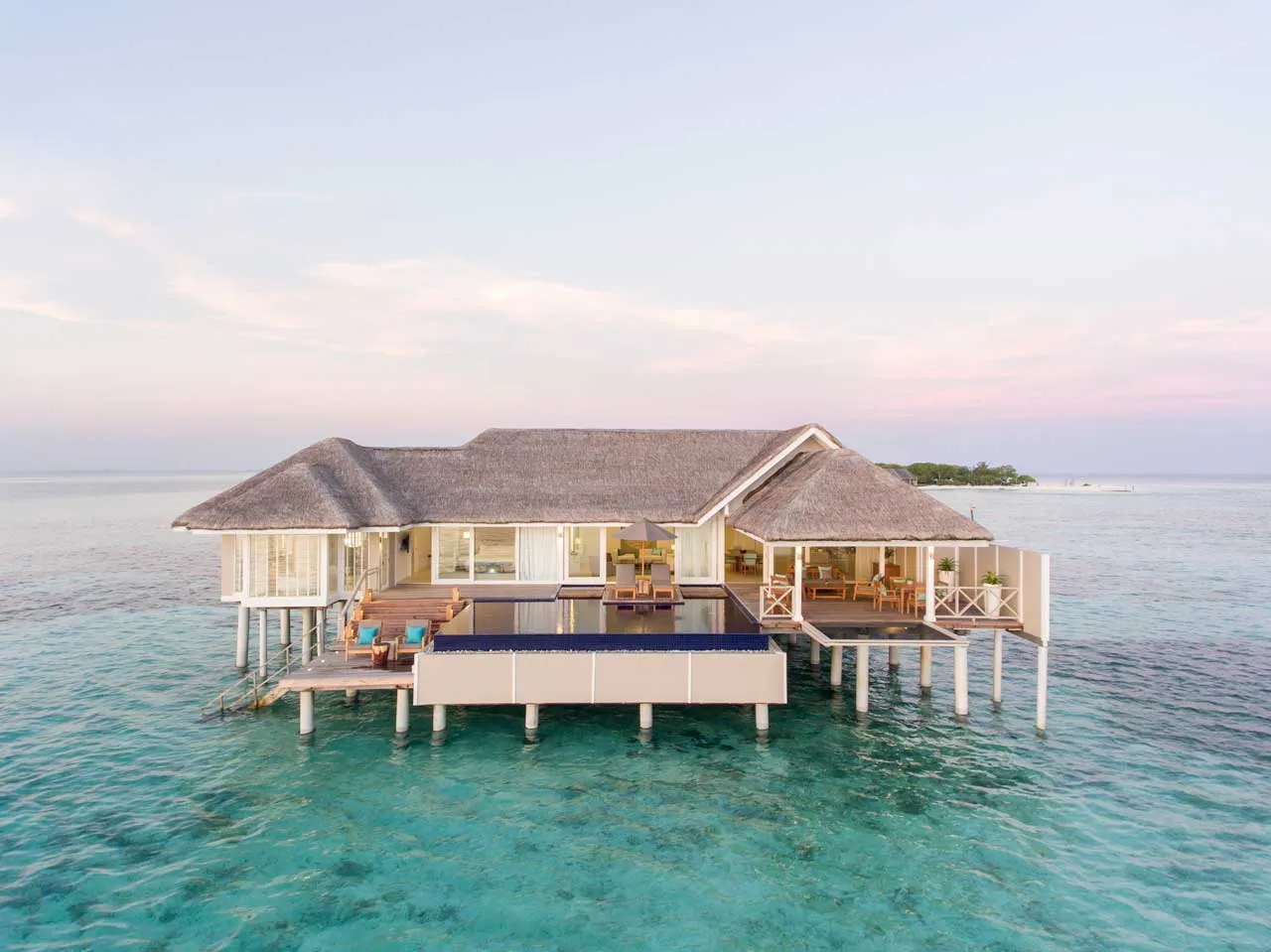 The LUX* Villa alone on the water, its pool on the deck