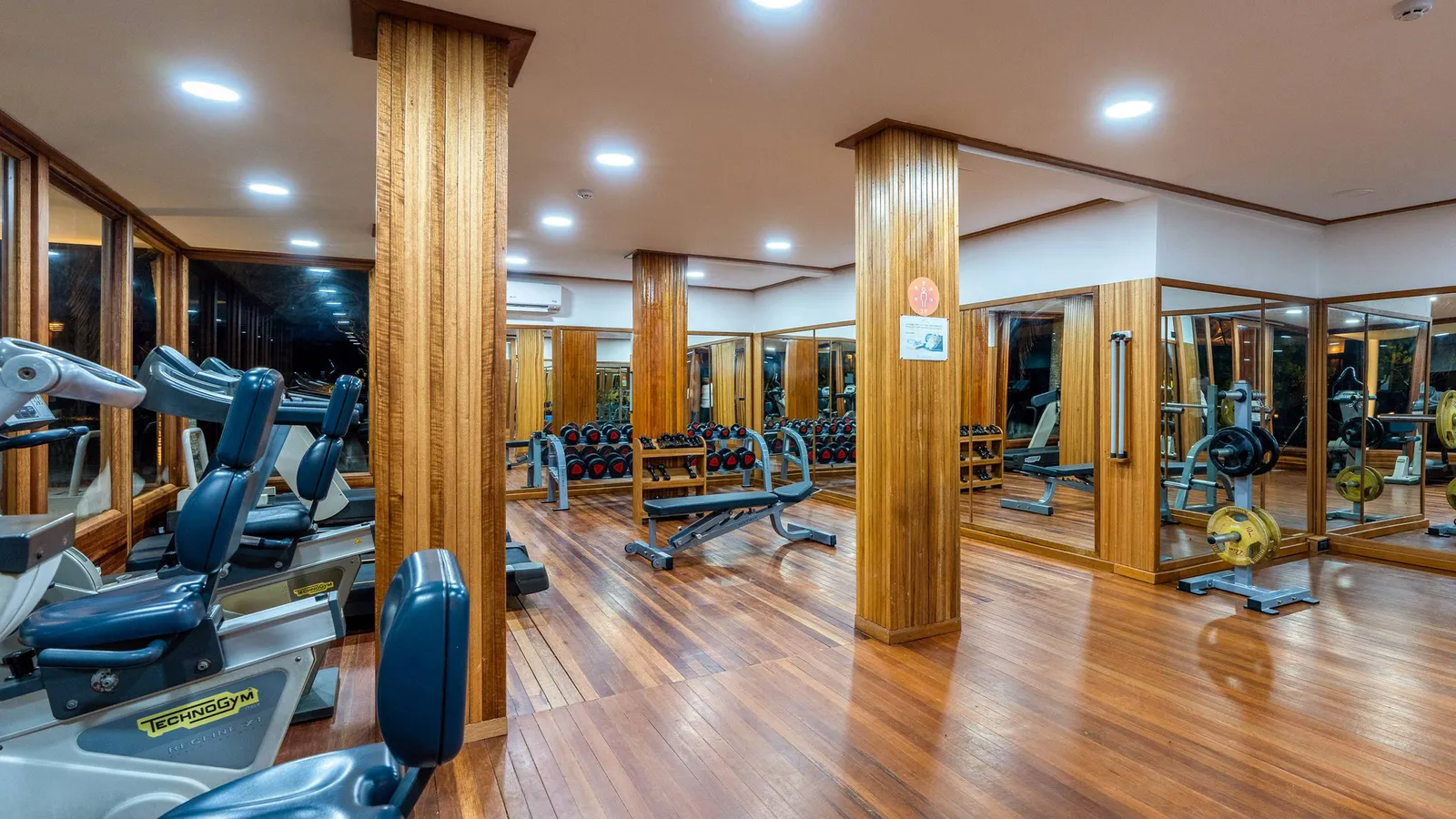 The gym, with its timber floor, machines and weights.