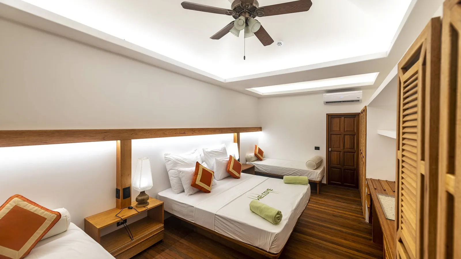 A renovated Garden Room: the double bed, the sofa bed, the timber wardrobe and the ceiling fan.