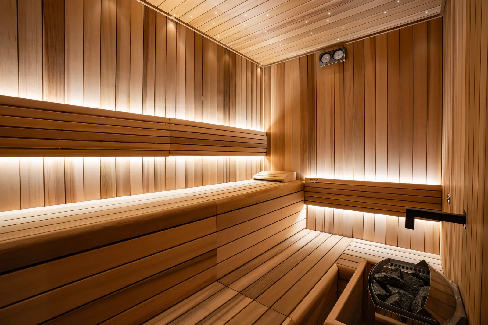 The spa’s Finnish sauna, all in pale wood, with tiered benches and lights under the slats.