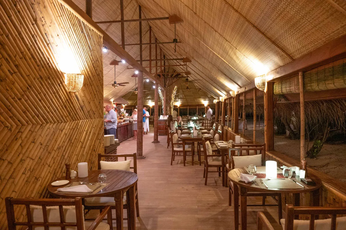 Ara Iru’s dining room under its bamboo roof, the tables laid and the buffet at the far end.