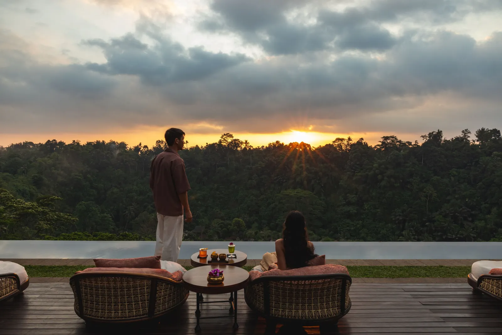 Ambar’s deck over the valley at sunset, 2 guests at the rail