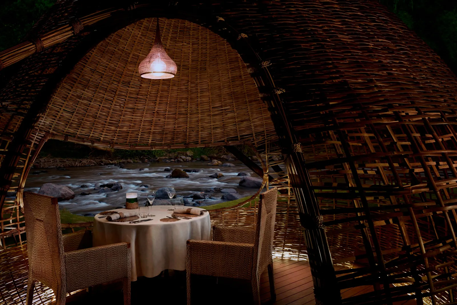 A table for 2 inside one of Kubu’s bamboo cocoons, the Ayung running below