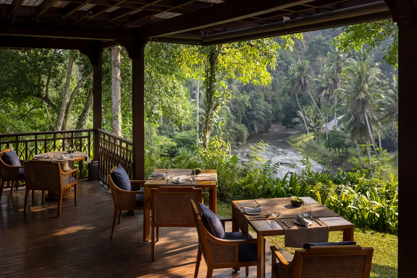 Sawah Terrace’s timber deck over the river, its tables laid
