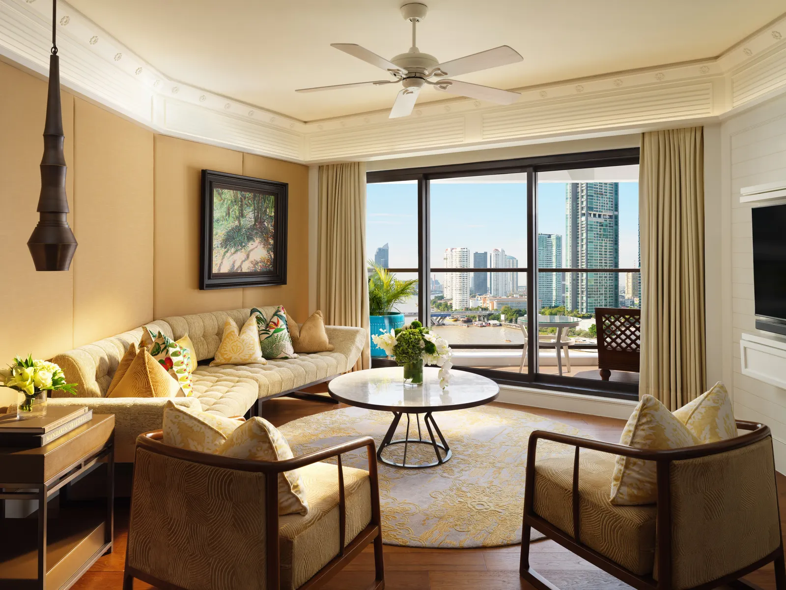 Deluxe One-Bedroom Suite: soggiorno nei toni dell’ocra e balcone sul fiume