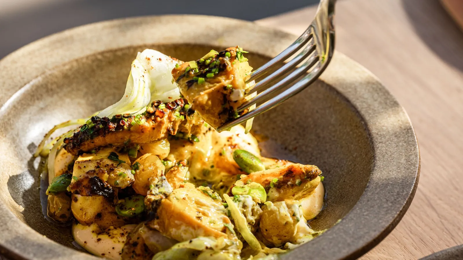 Ottolenghi dishes on a sunlit table