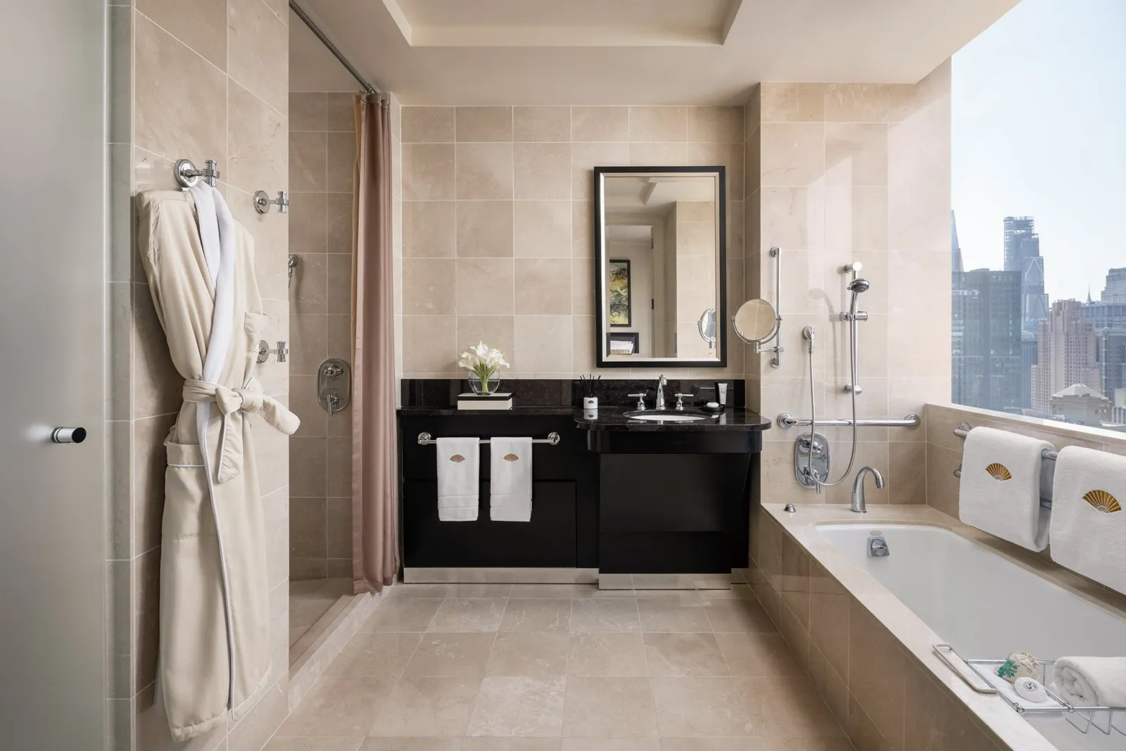 Marble bathroom with a window-side bathtub and separate shower