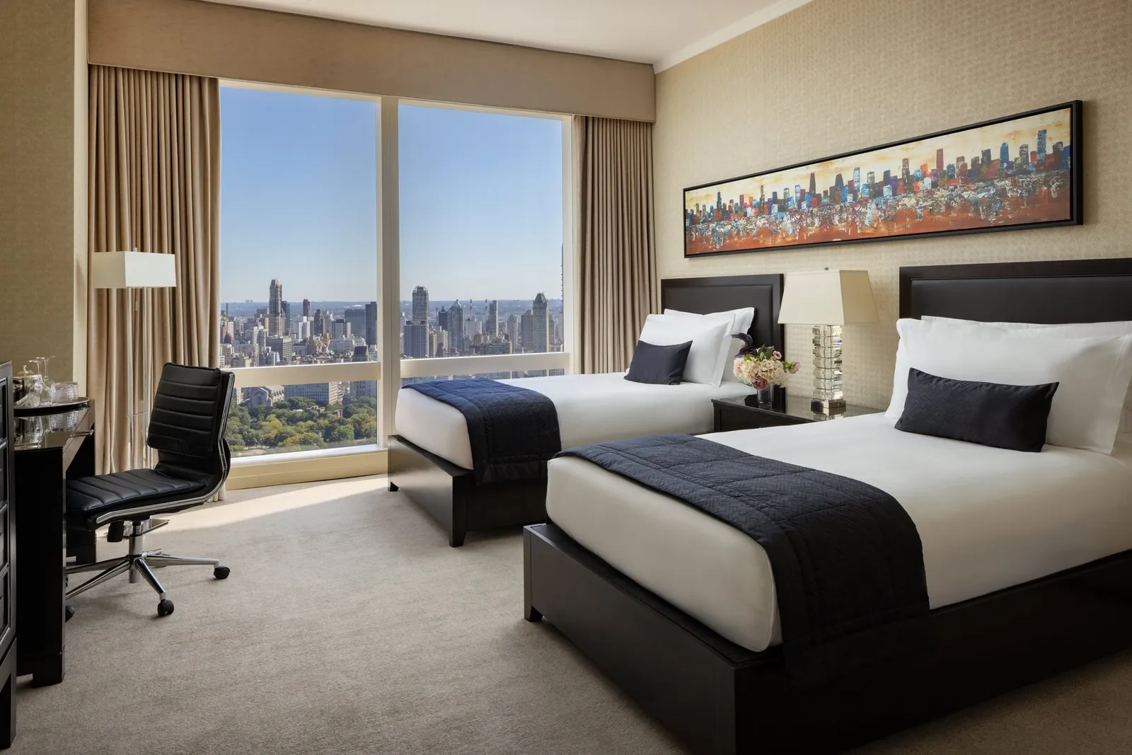 2 single beds, a desk and an armchair beside the windows