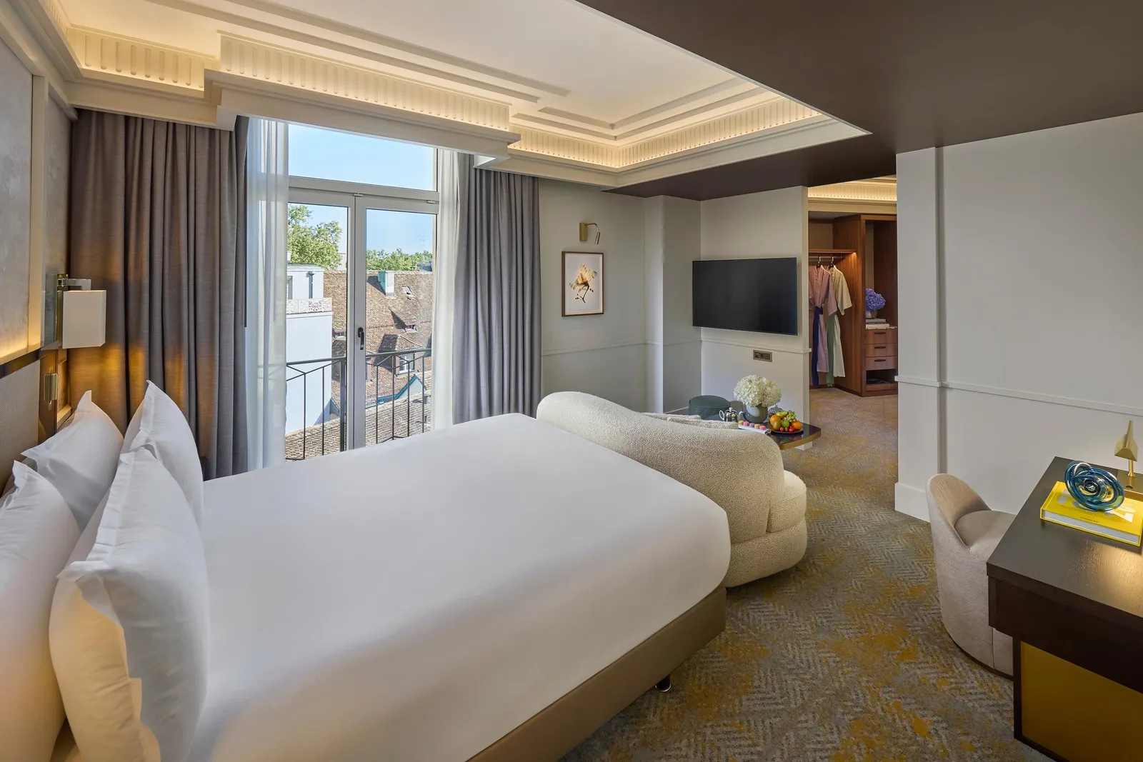 King bed, armchairs and mirrors in the Deluxe Room
