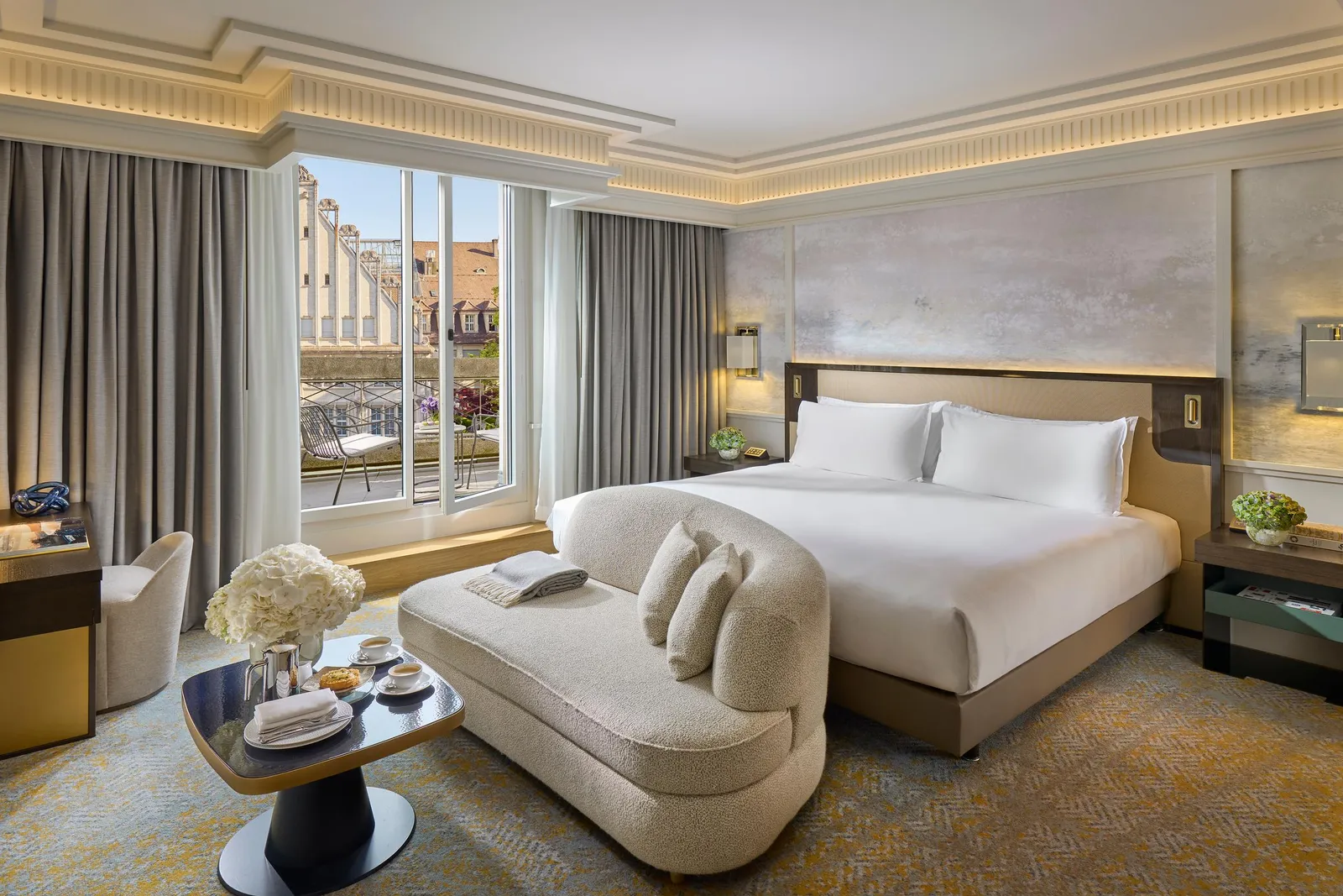 Bed, armchair and terrace doors in the Deluxe Terrace Room
