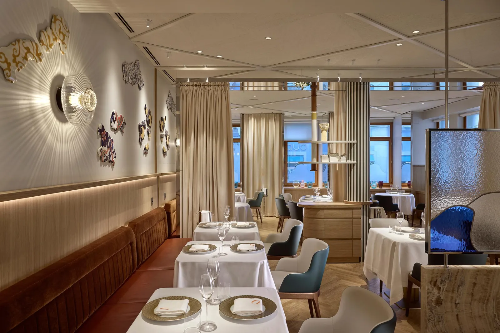Laid tables and wood-panelled walls in the ORSINI dining room