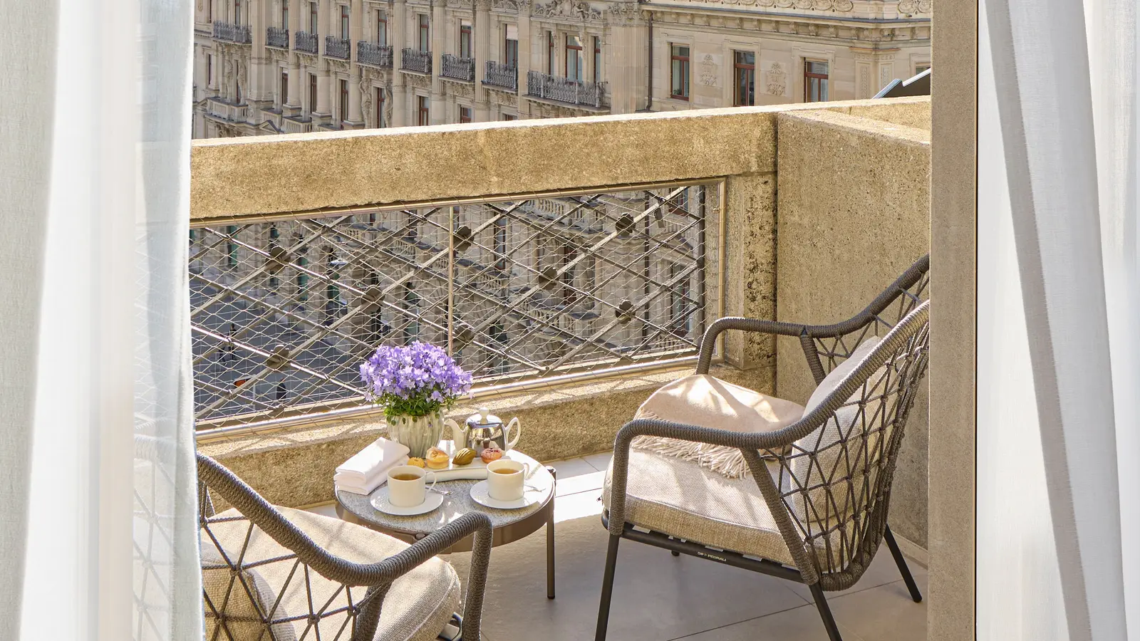 2 chairs and a small table on the Junior Terrace Suite balcony