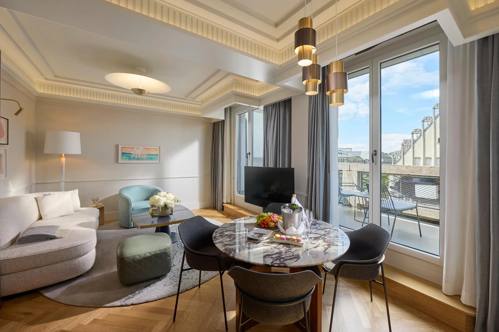 Sitting area with a table and sofa in the Mandarin Rooftop Suite
