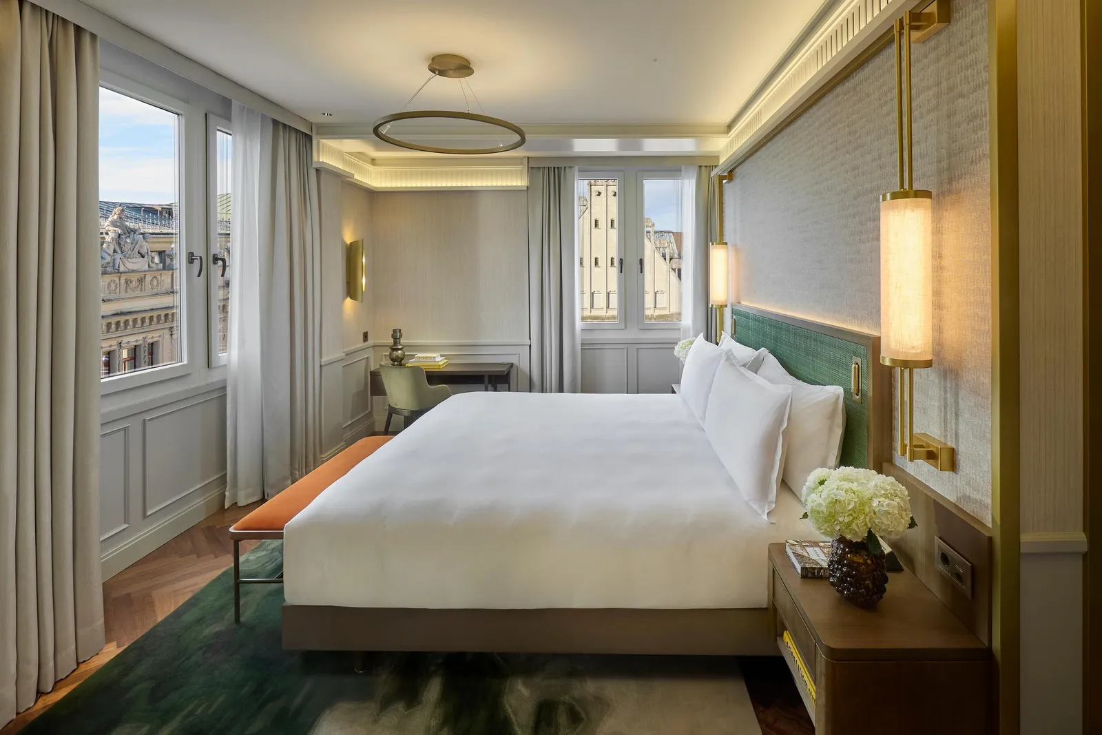 Penthouse bed with a panelled headboard and windows