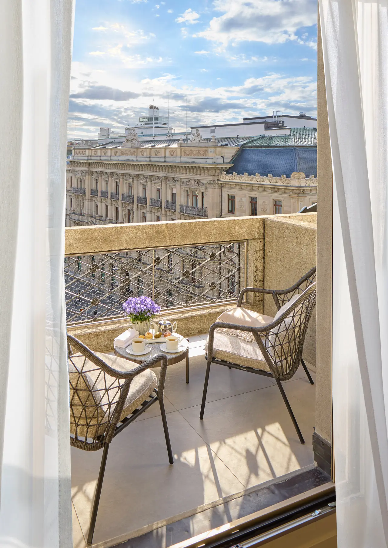 Connecting suite balcony with chairs and a small table