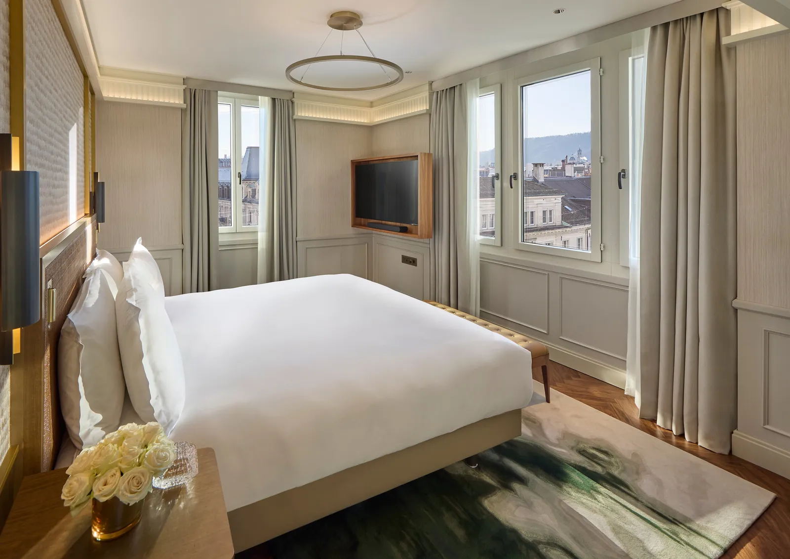Bed and city-facing window in the 2-bedroom suite