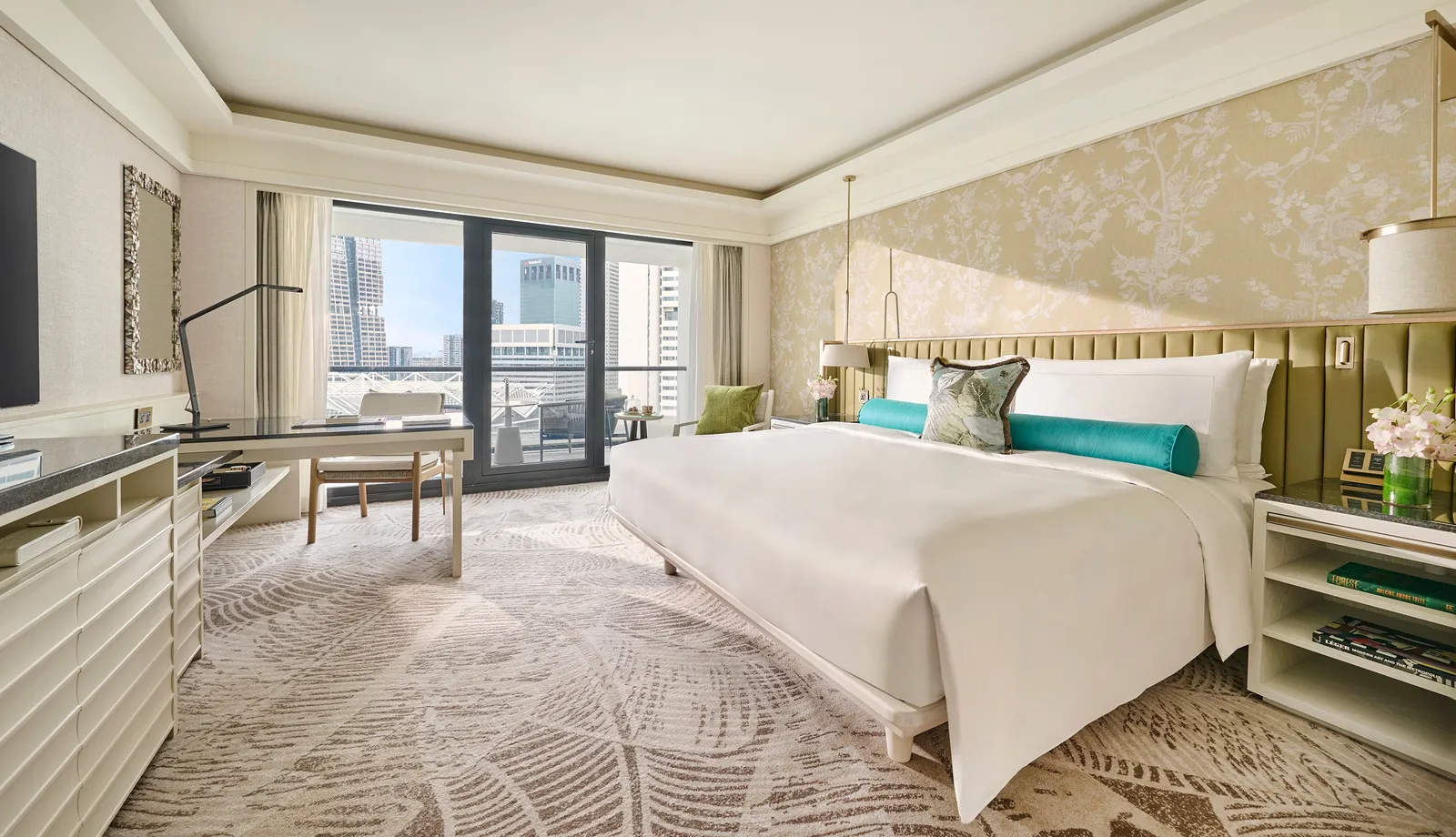 The Deluxe Room with Balcony: the king bed with its green headboard, the desk and glazed doors onto the balcony.