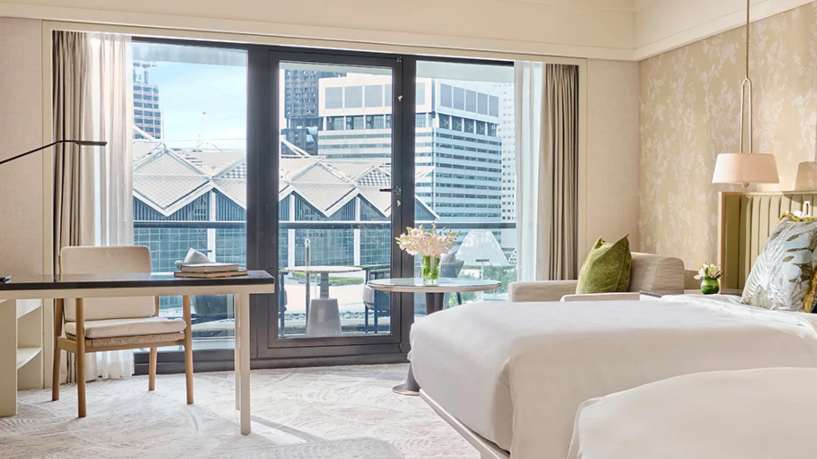 The Premier Room with Balcony: 2 beds, the desk and the glazed door to the balcony, with the city opposite.