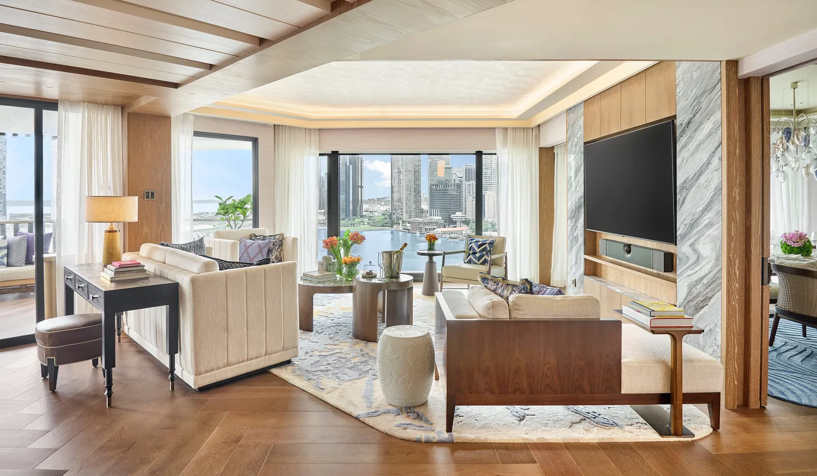 The living room of the Presidential Suite: 2 sofas, a desk and the corner window onto the bay.