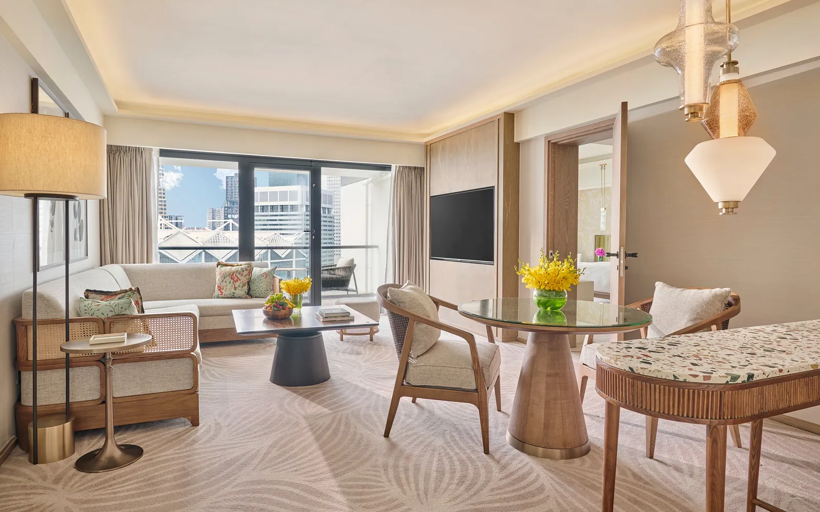 The living room of the Residential Suite with Balcony: the sofa, a round table, a terrazzo counter and the balcony.