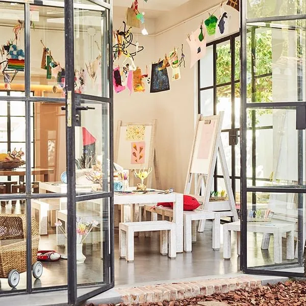 Children’s art room, featuring white wooden easels and tables under a paper banner at the Marbella Club