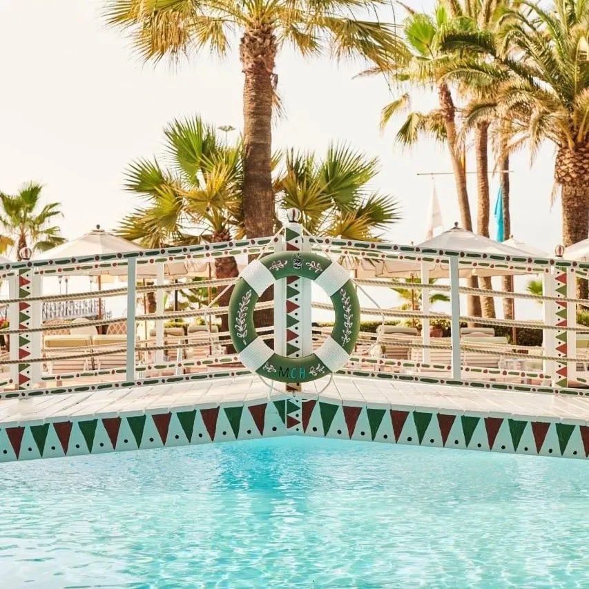 Decorative bridge over the pool, with a life preserver hanging from the railing at the Marbella Club