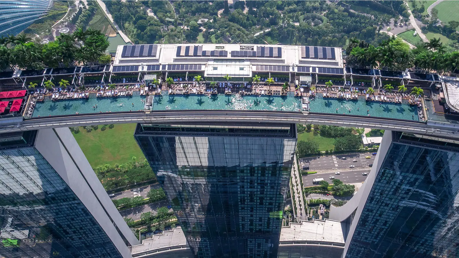 The pool from above: a strip of water as long as the roof, loungers down one side, resting on the glass towers.