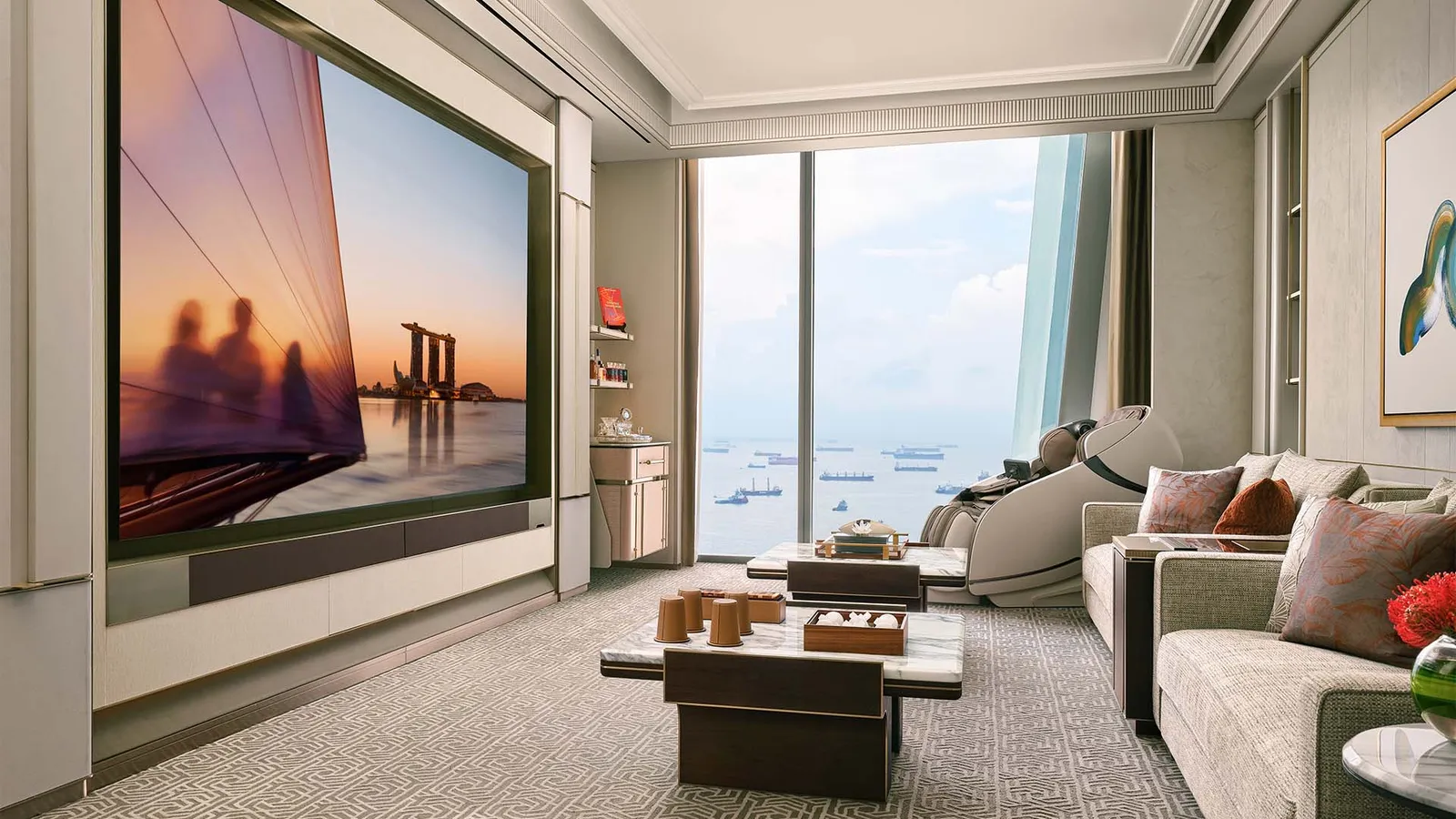 Chairman Suite: the media room with its wall screen and sofas, ships in the strait through the window.