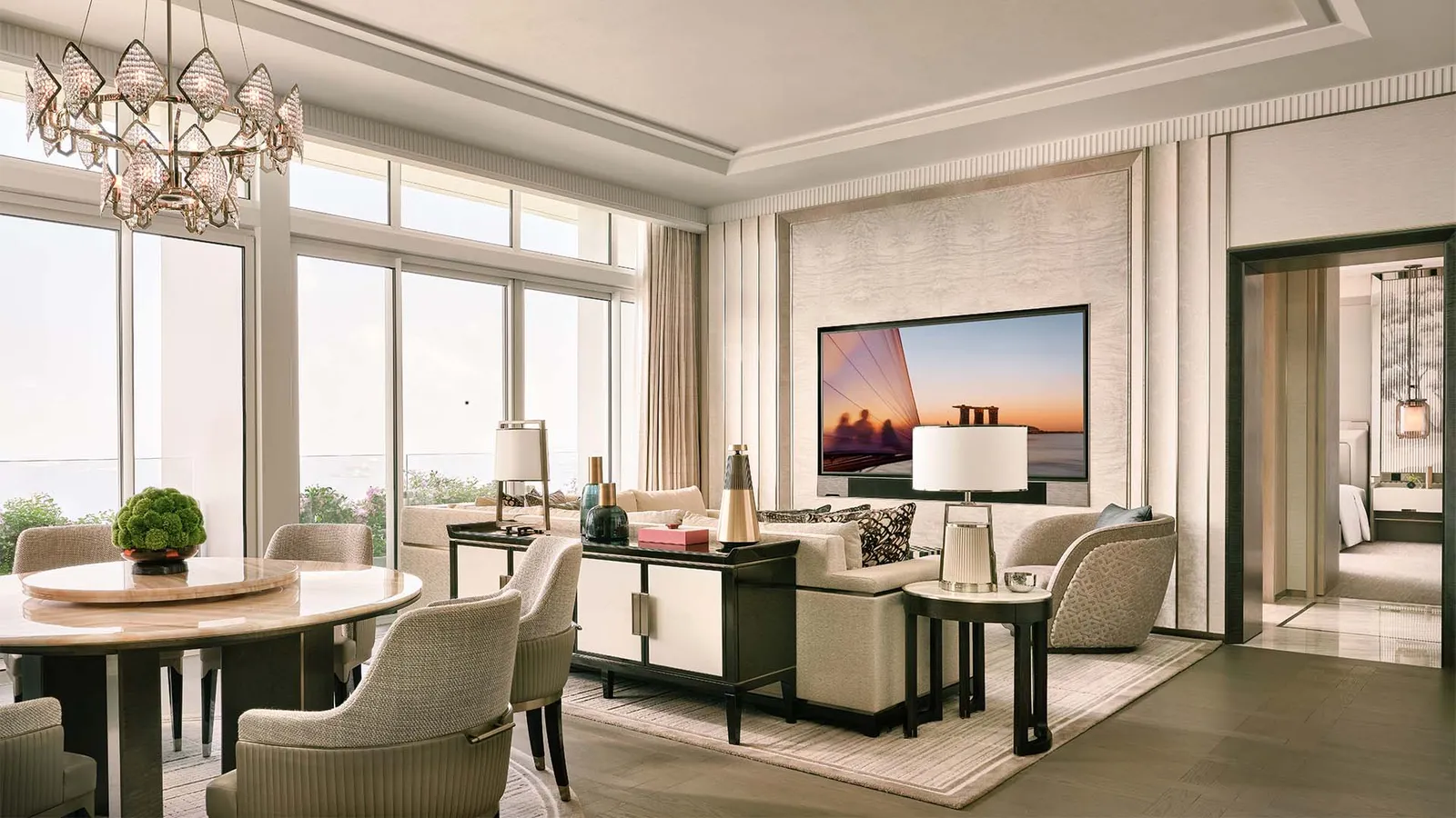 Harbour Suite: the dining room with its round table and the sitting room by the windows.