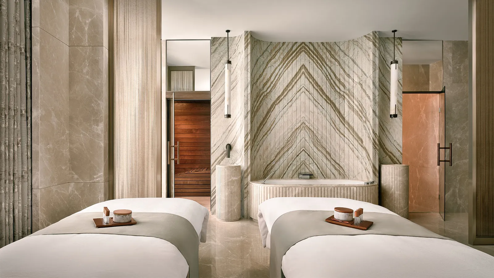 Horizon Suite: the massage room with 2 treatment beds and the marble bath behind.