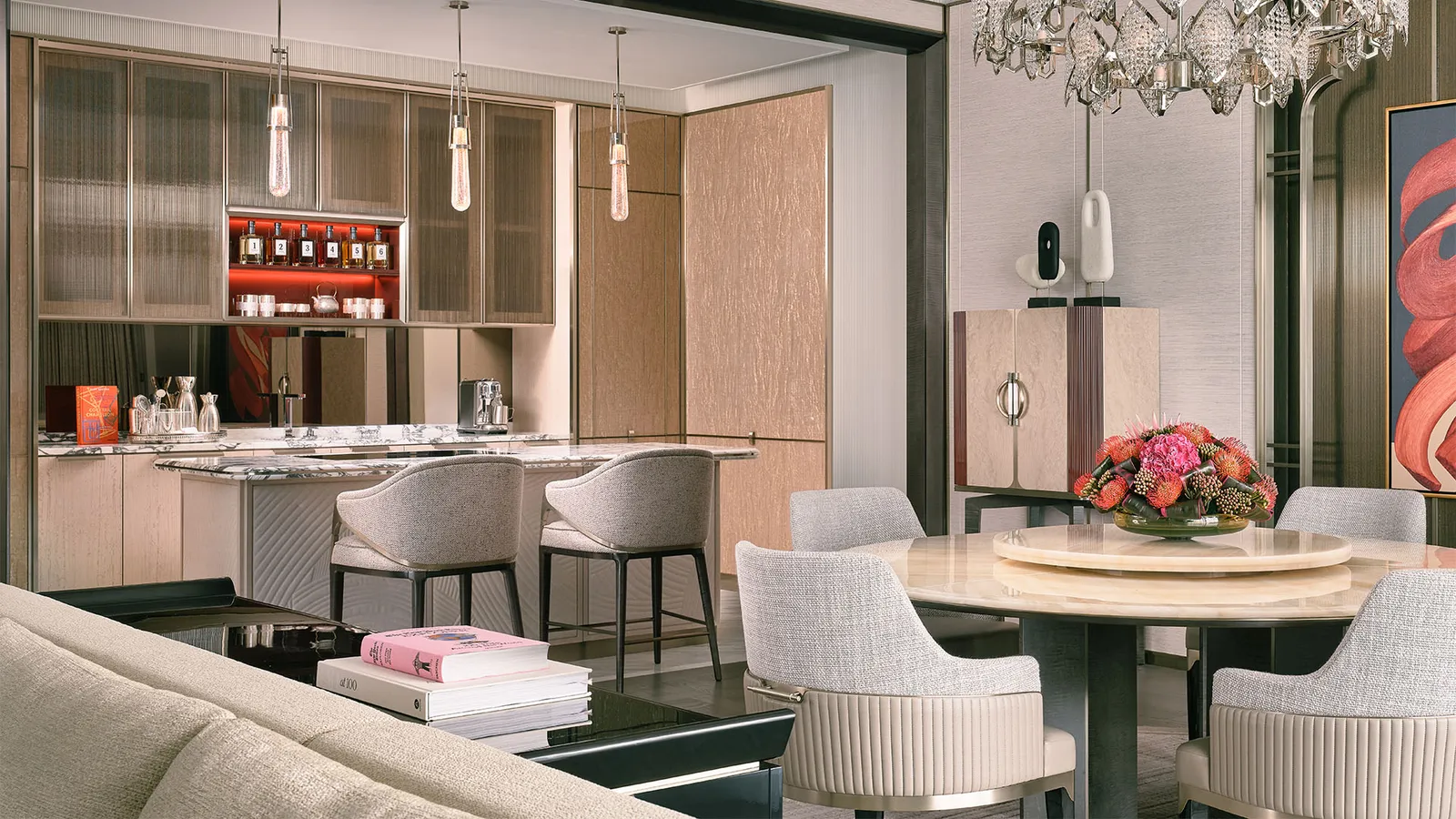 Marina Suite: the Social Bar with its stools, the round dining table and the crystal chandelier.