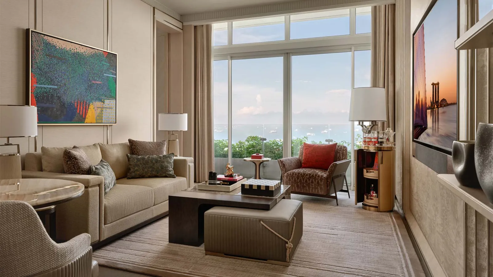Paiza Bay Suite: the living room with a sofa and an armchair facing the window on the sea.