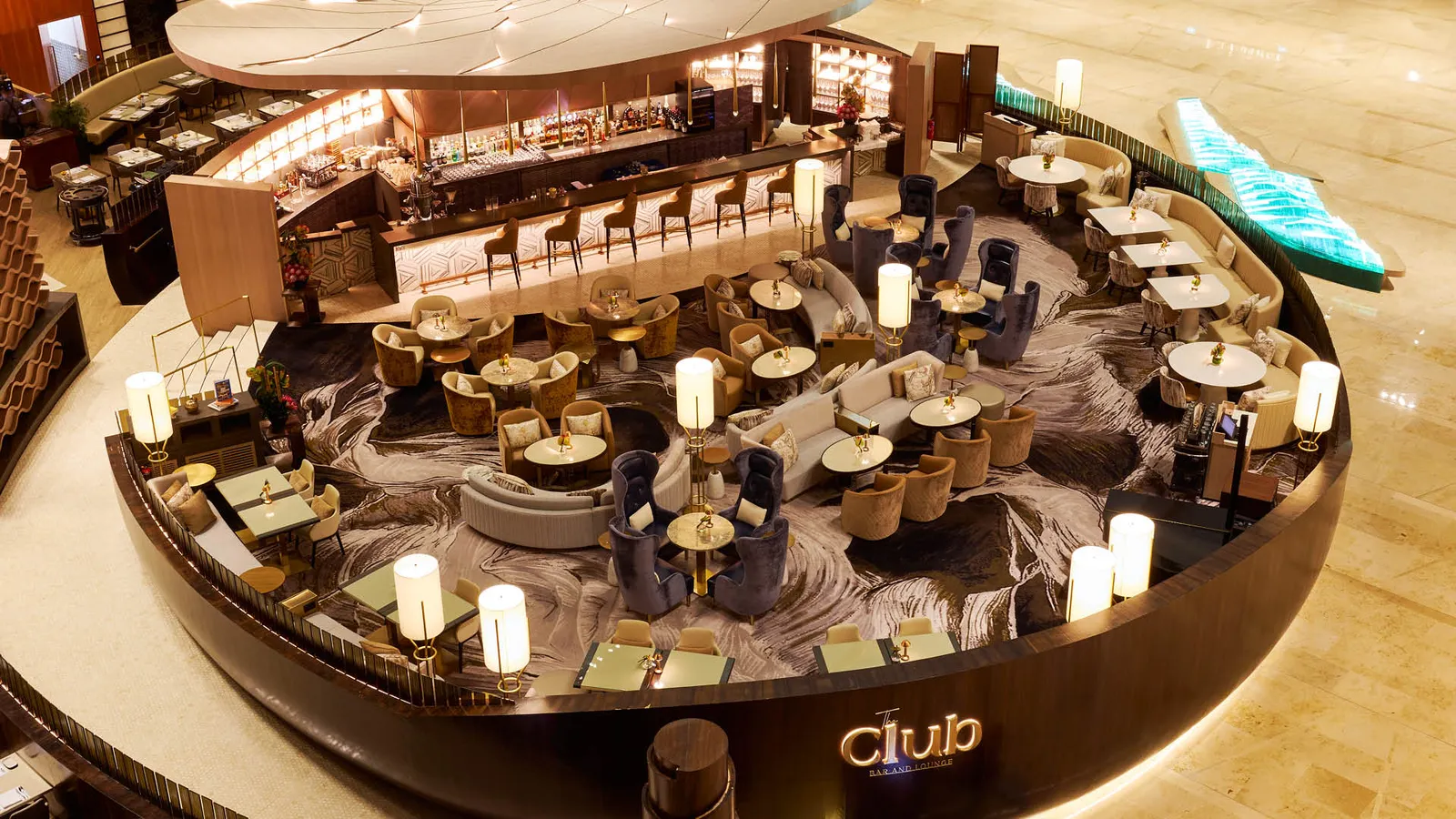 The Club from above, in the lobby: an oval island with the bar counter at its centre and small tables around it.