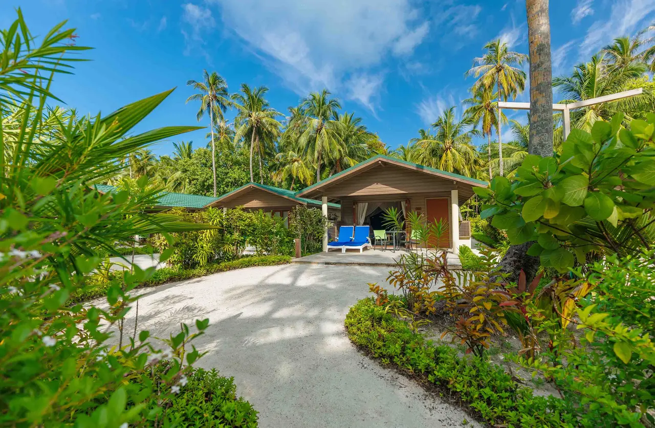 A Jacuzzi Beach Villa among trees and sand