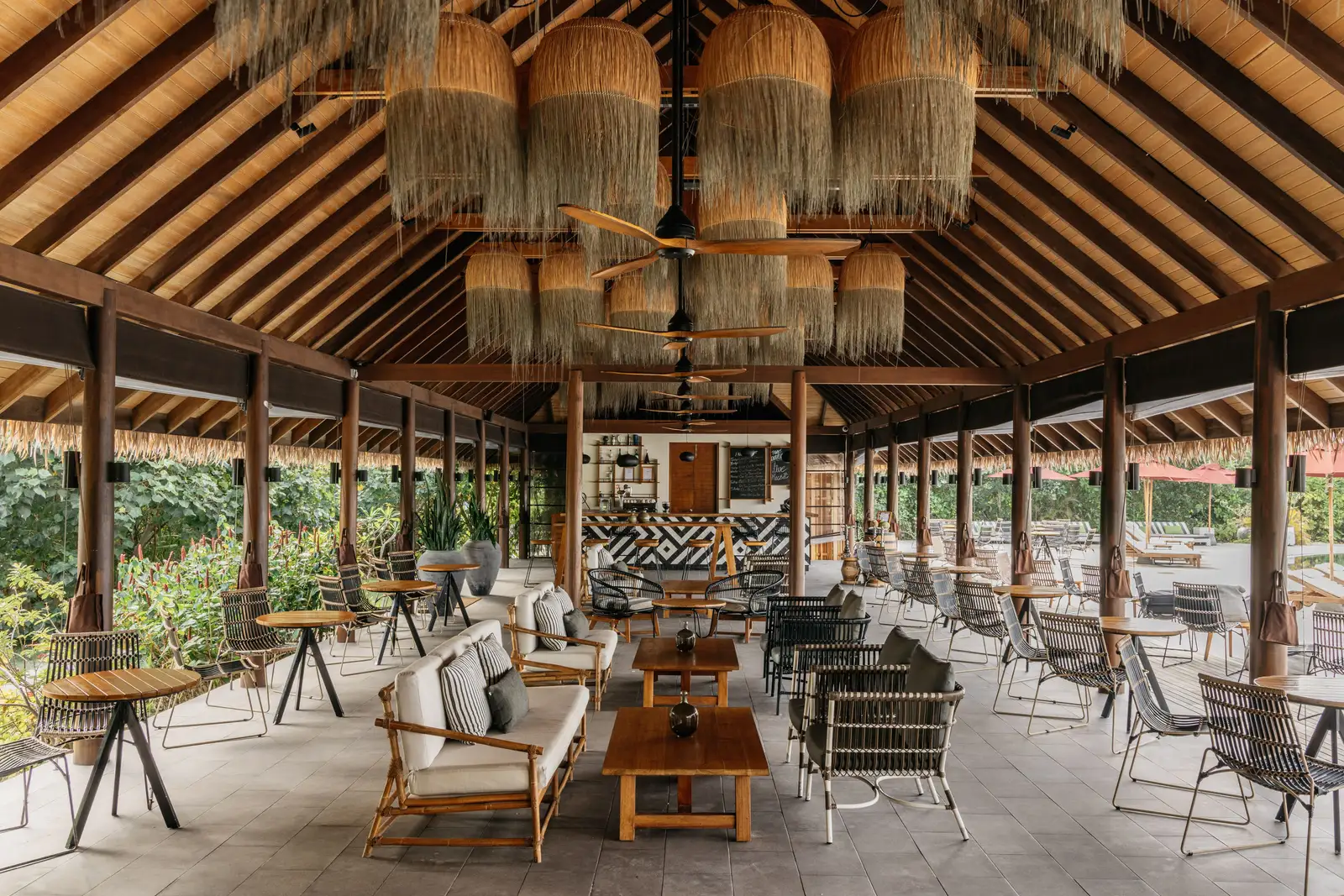 Breeze, the poolside bar, with its timber ceiling, woven lamps and low sofas.