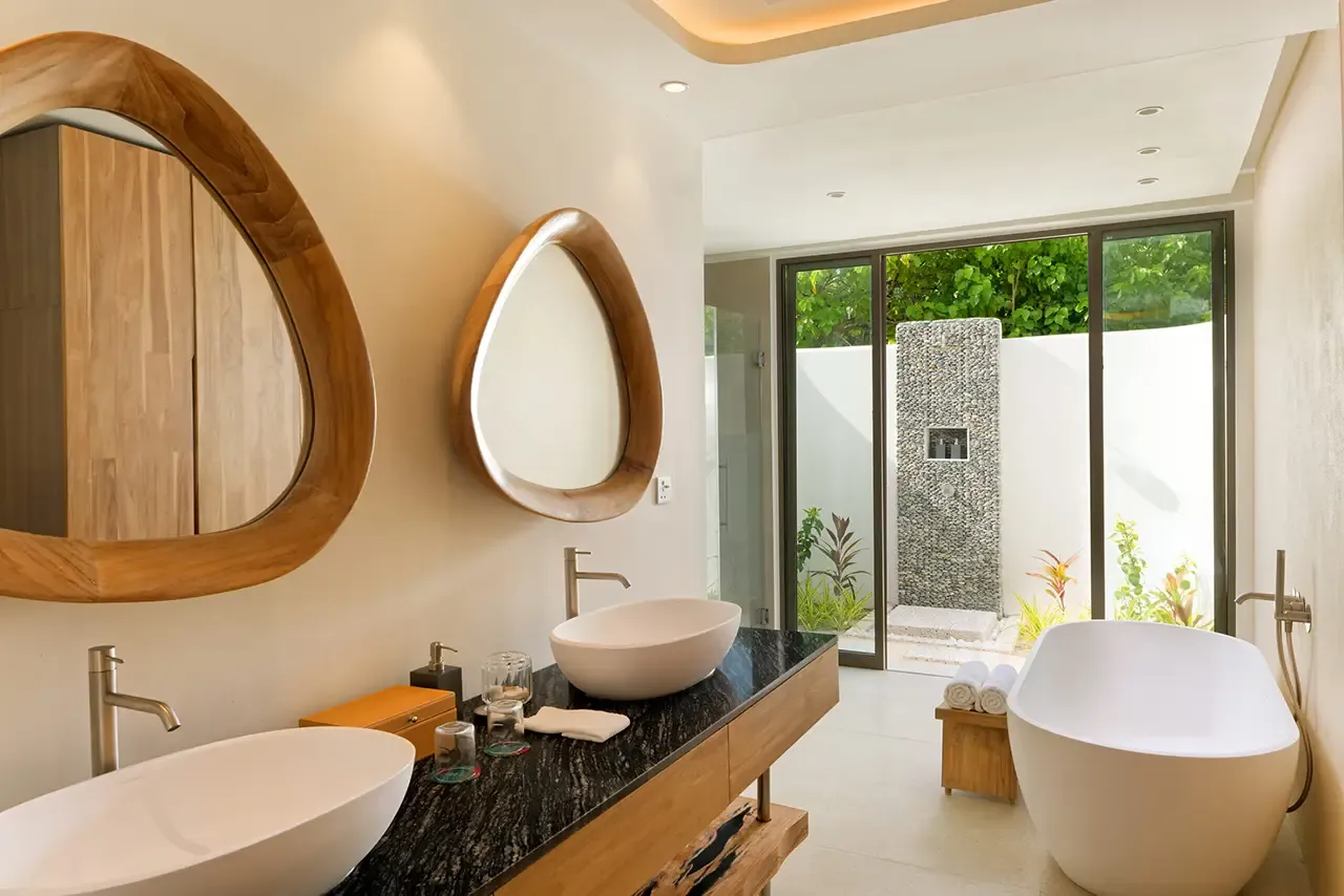 The bathroom with a bath and 2 basins.