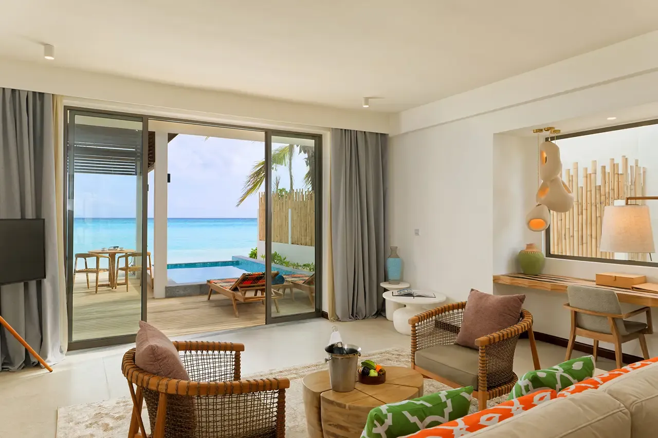 The living area with doors opening towards the sea.