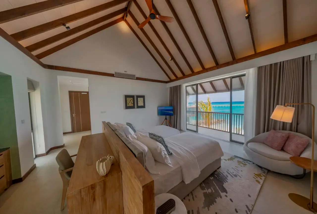 The bedroom with its bed and sea-facing balcony.