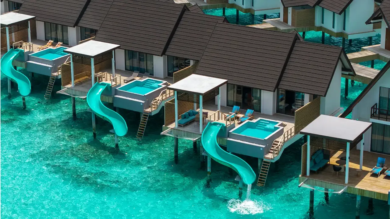 Overwater villas with pools and slides in the image published for the Water Pool Villa with Slide.