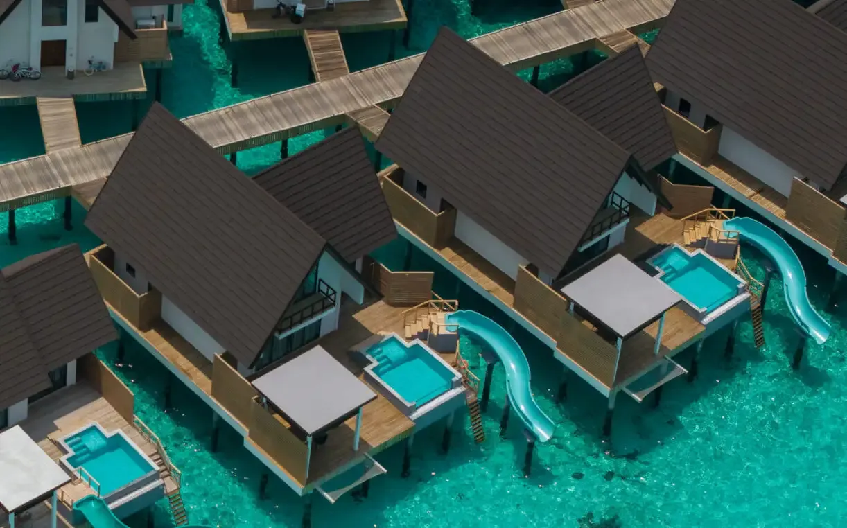 The aerial view of villas and slides in the official image.