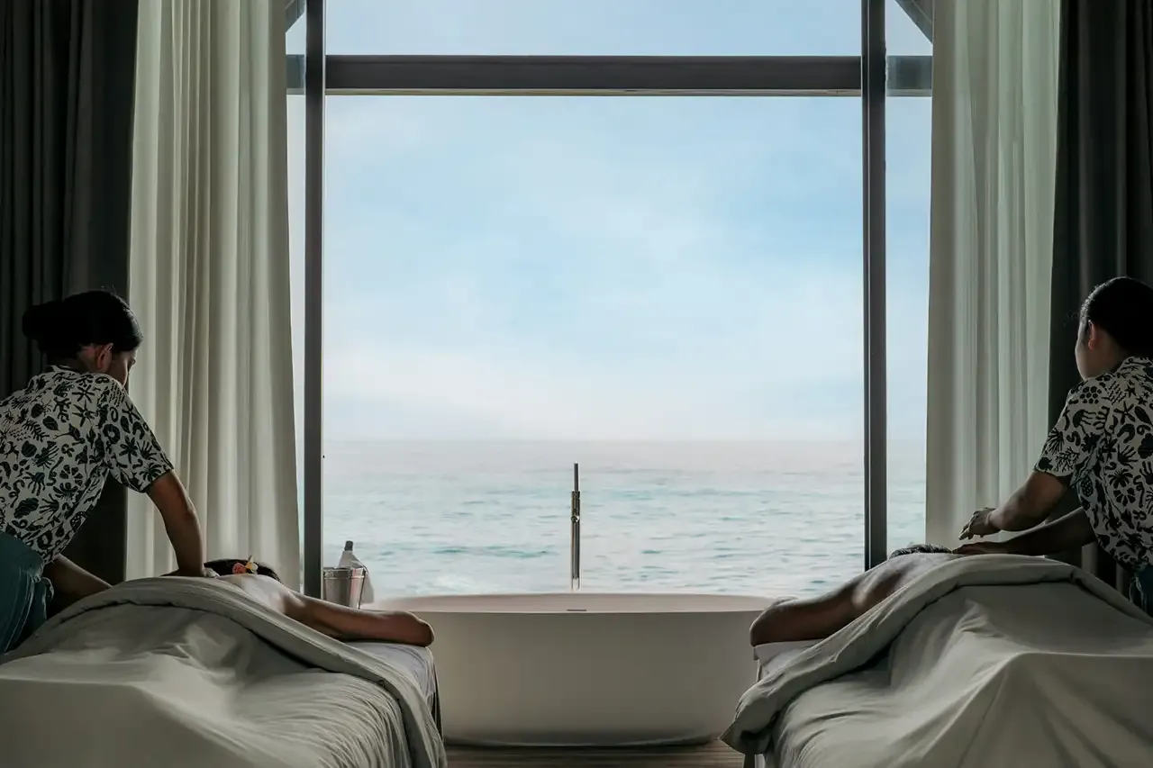 2 massage beds beside windows onto the sea.
