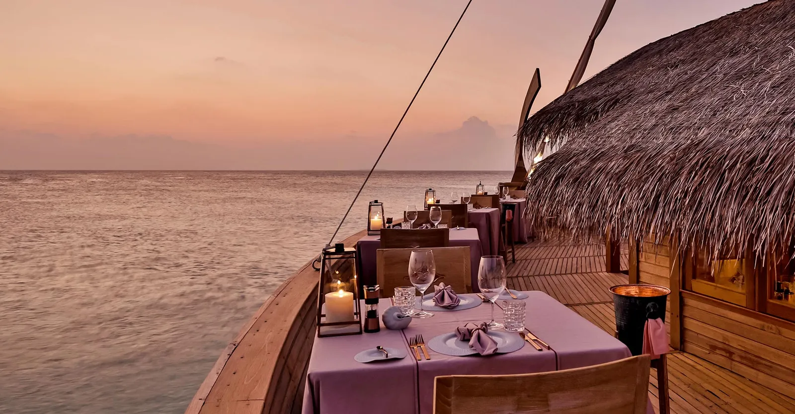 Ba’theli’s tables on the boat’s deck, between the timber prow and the thatched roof