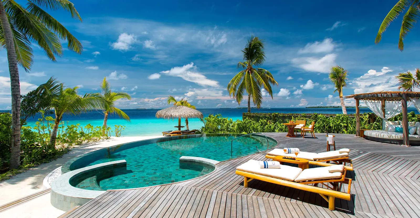A Beach Pool Residence: the 60 m² pool, the loungers and the sea beyond the deck