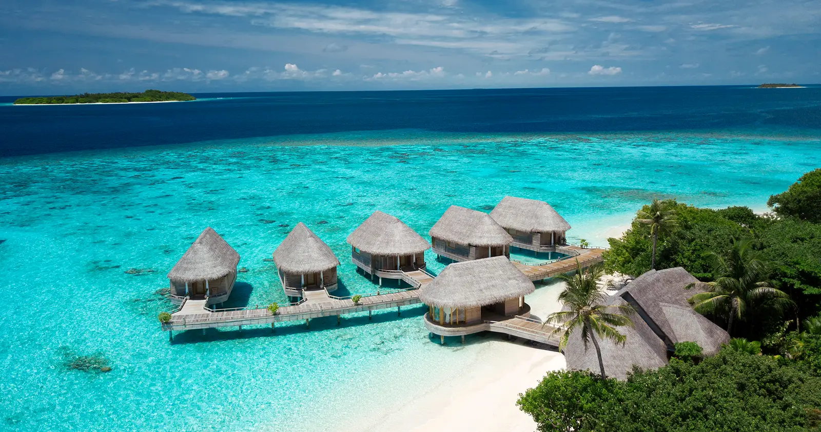 The Serenity Spa’s overwater pavilions from above, beside the beach