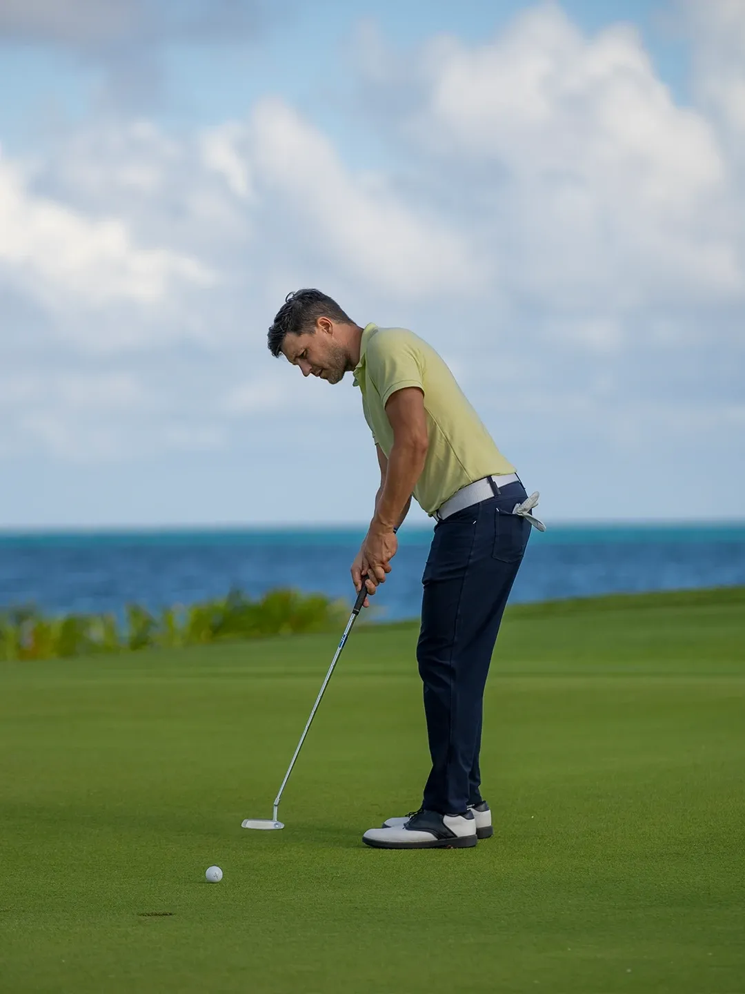 A golfer on a green at the Moon Palace course