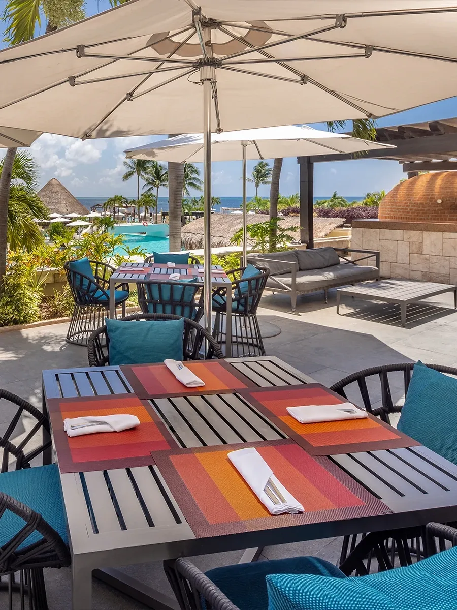 Colourful tables at Pepe’s Pizza beneath parasols